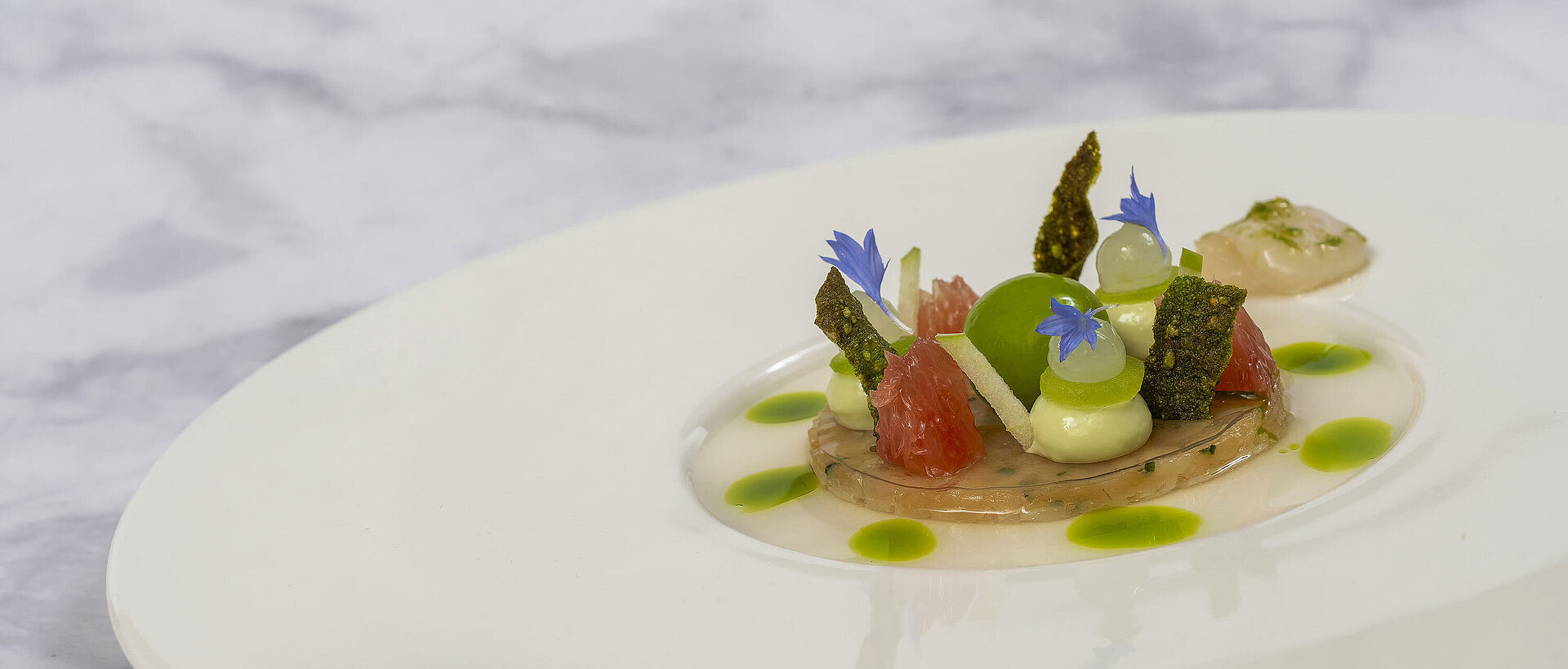 Gericht mit Jakobsmuscheln Gericht mit Jakobsmuscheln und kunstvoller Präsentation in der Orangerie im Maritim Hotel Timmendorfer Strand.